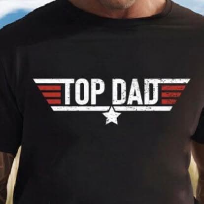 A man wearing a black Top Dad tee with a star.